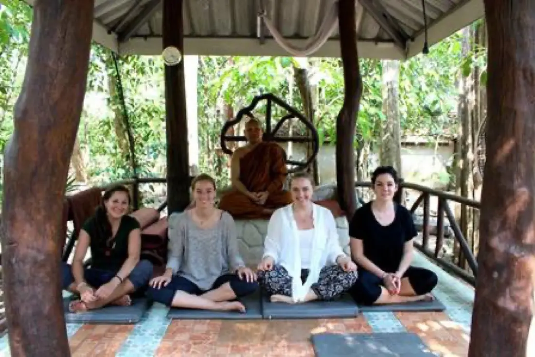 Volunteers meditating in the temple hall