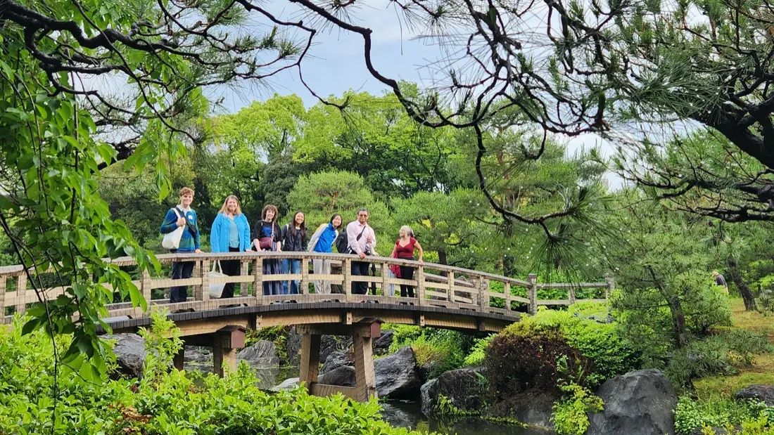 The group on a bridge in a Japanese garden