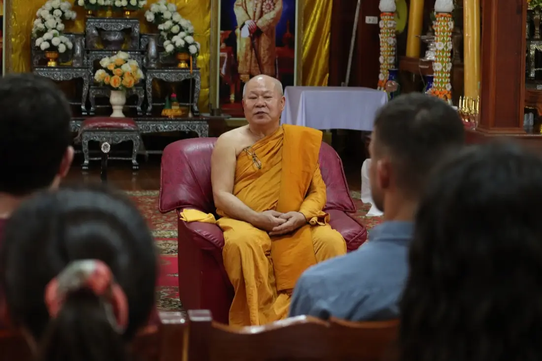 Monk leading a meditation session at a temple