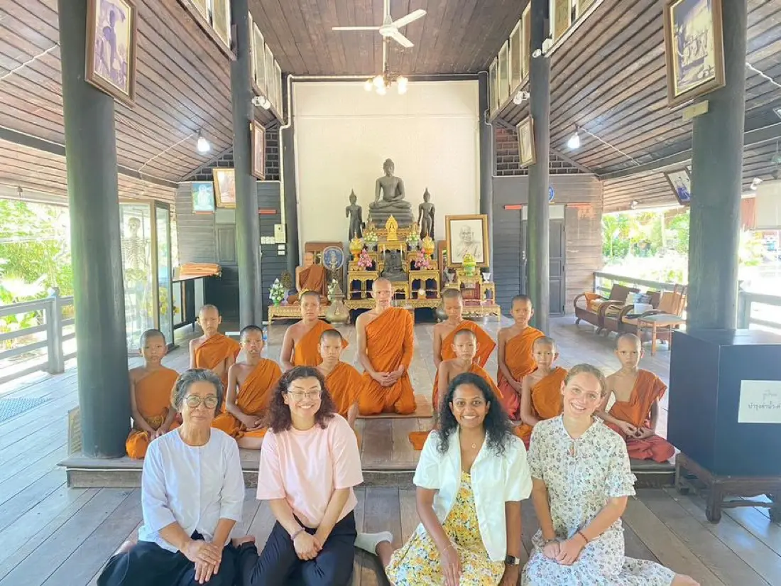 Volunteers and novice monks in the temple hall at Hua Hin