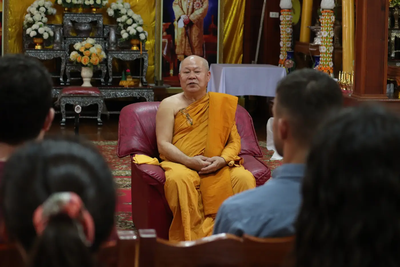 A monk giving a Dharma talk to the group at a Thai temple